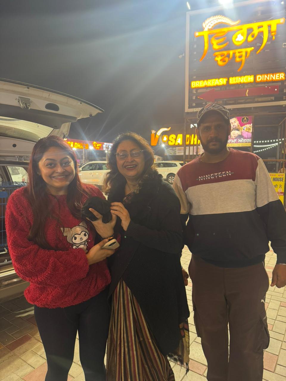 Happy family with new puppy from top Punjab dog breeder